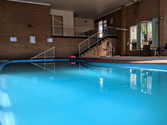Close view of the indoor pool with handrail and brick surrounds