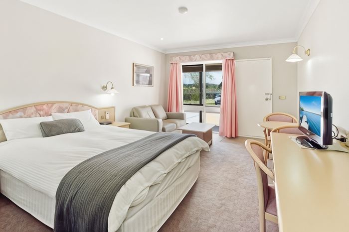 Executive Queen Room with a queen bed and a comfortable sofa